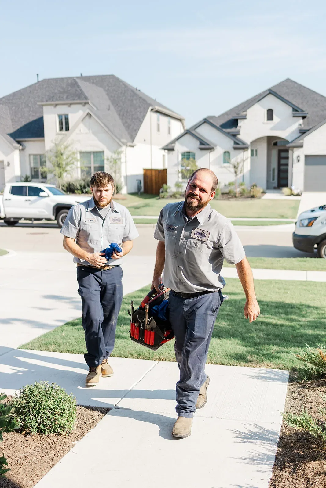 Underwood plumbers walking up with tools