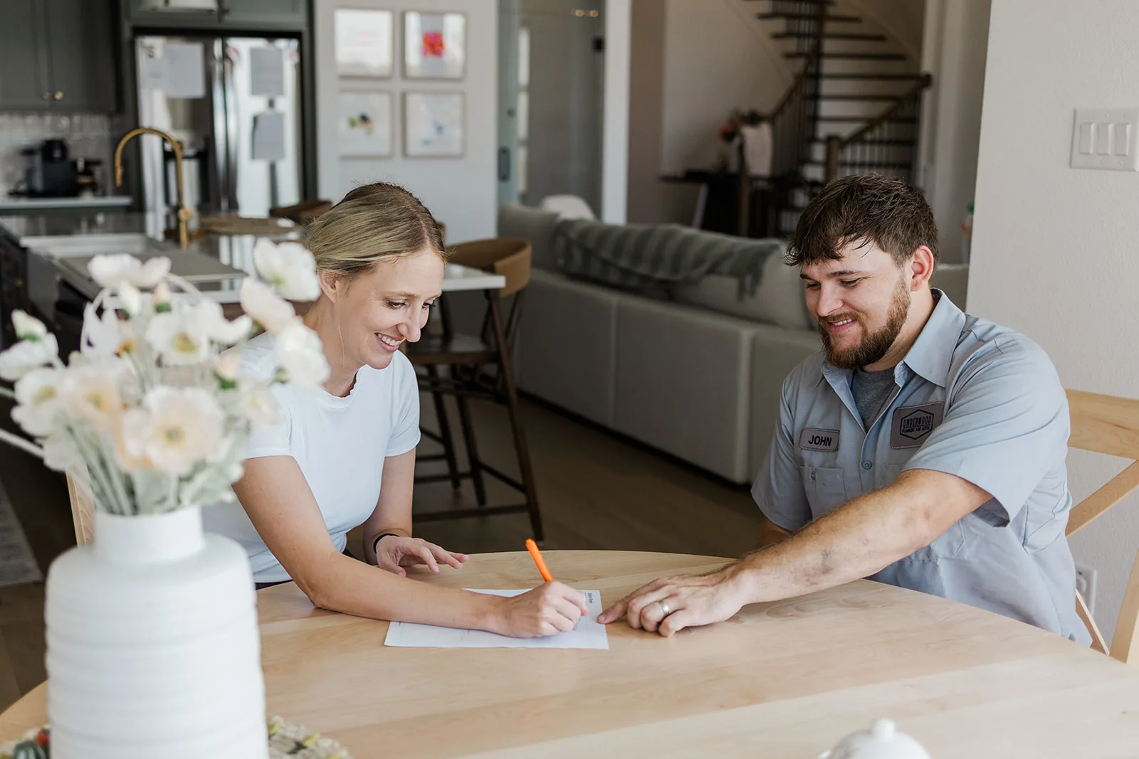 Underwood plumber reviewing the inspection with homeowners at the kitchen table